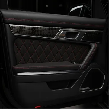 Custom automotive door panel upholstery with black leather and red stitching by EM Upholstery Technology