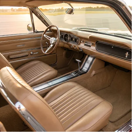 Expert automotive upholstery technician hand stitching a custom leather steering wheel showing premium craftsmanship and professional auto interior restoration work