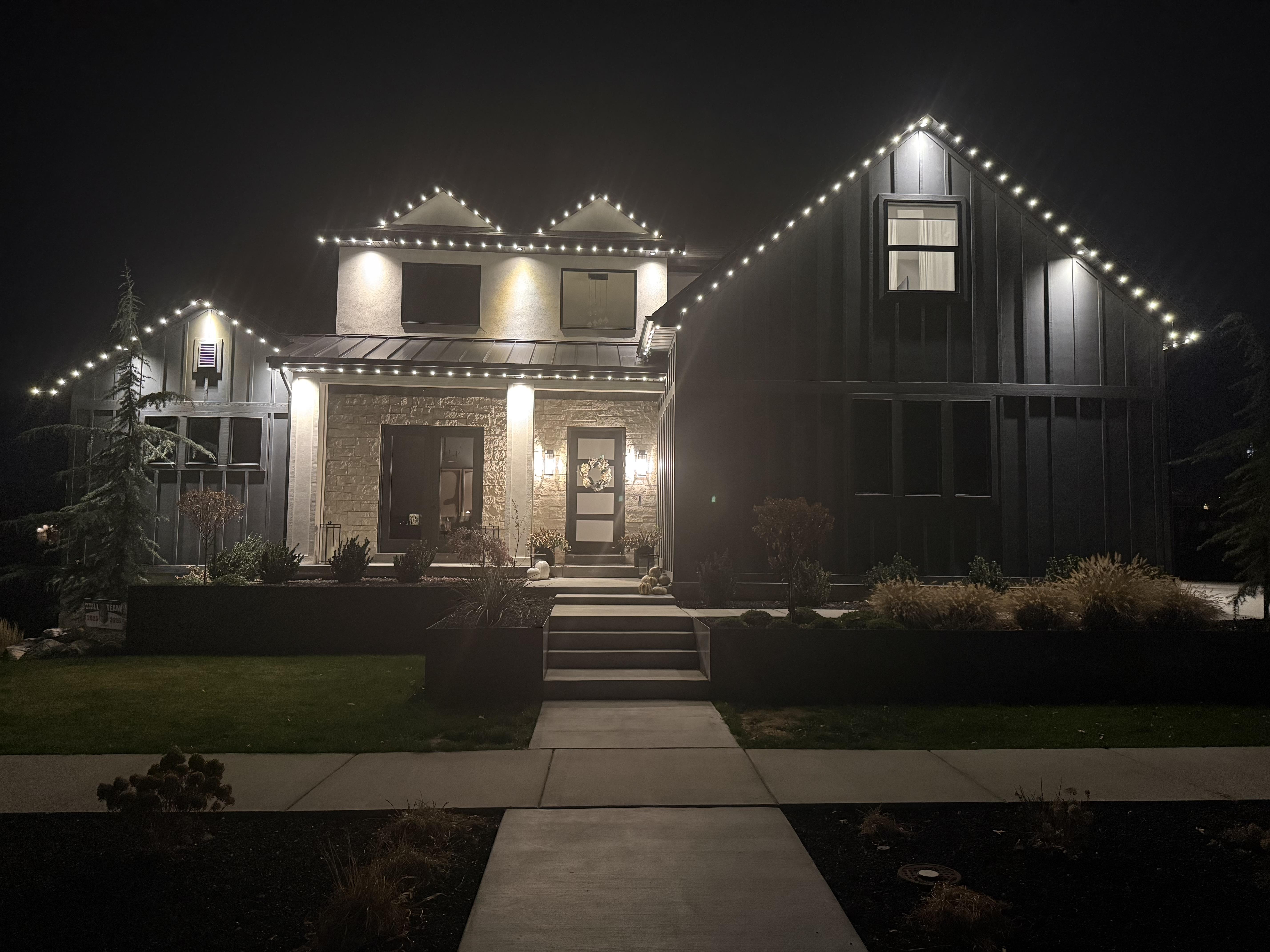 Professional Christmas lights on a house at night in Payson Utah by Max Mowing