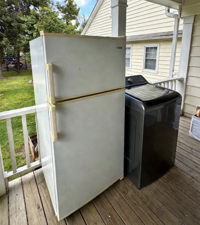 Appliance removal service in Northwest Arkansas hauling away old refrigerator