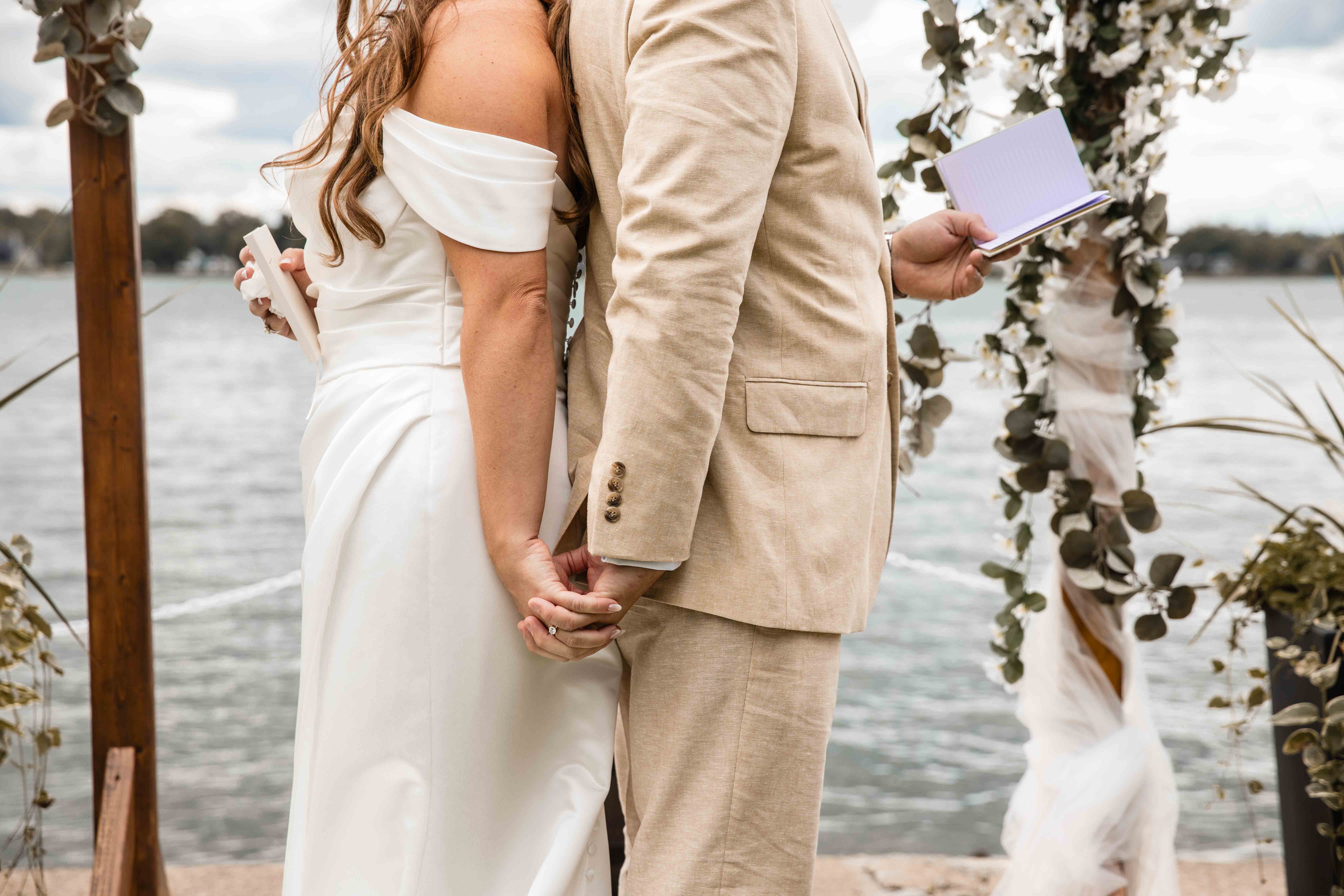 A wedding party on a balcony inside a grand building.