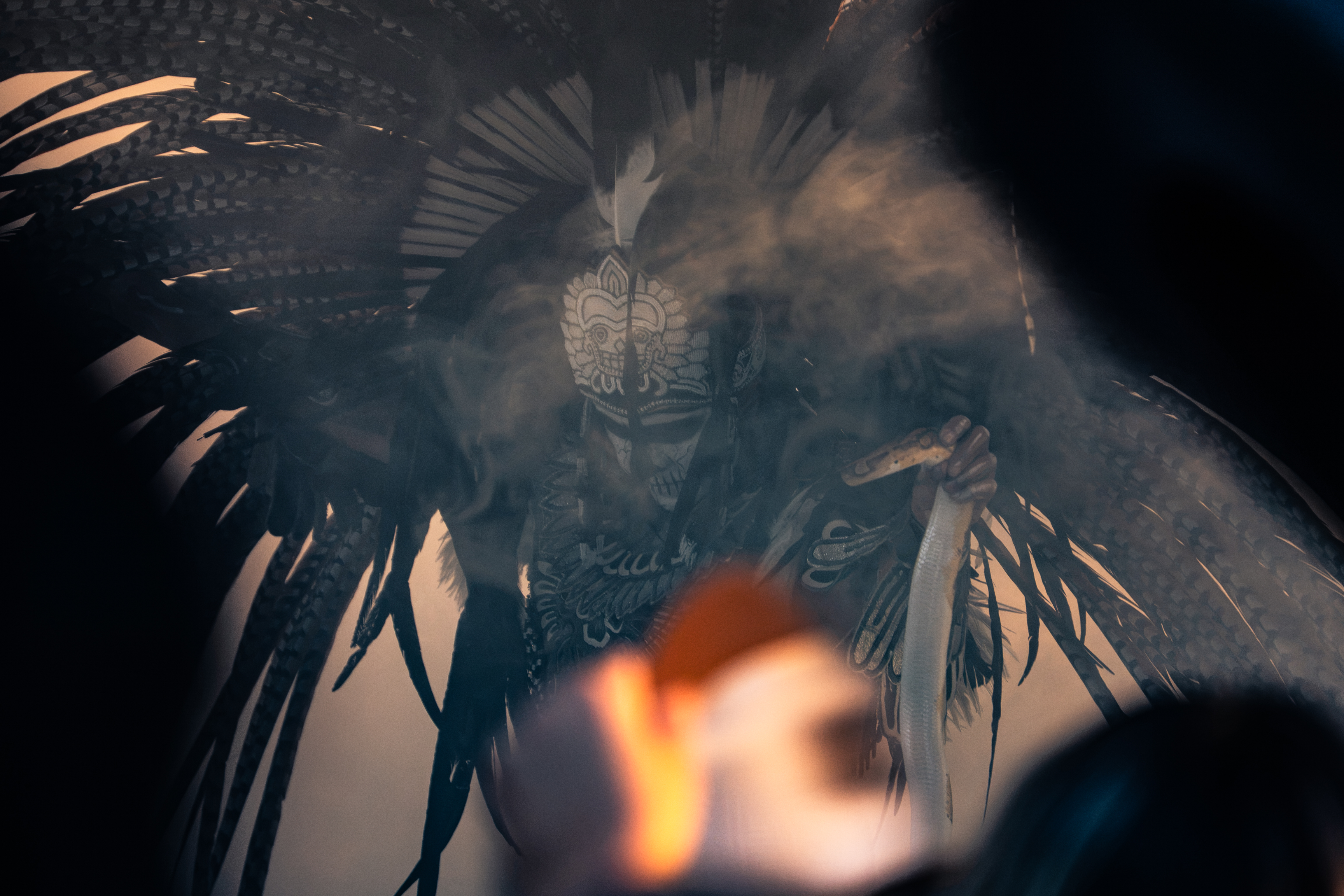 A Danzante in traditional Mexika regalia dancing powerfully in the Treasure Valley landscape