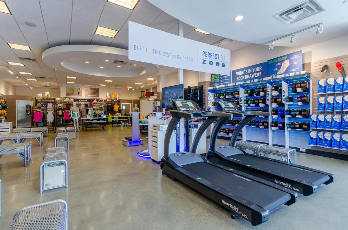 a silhouette of a woman running on a hill at sunset