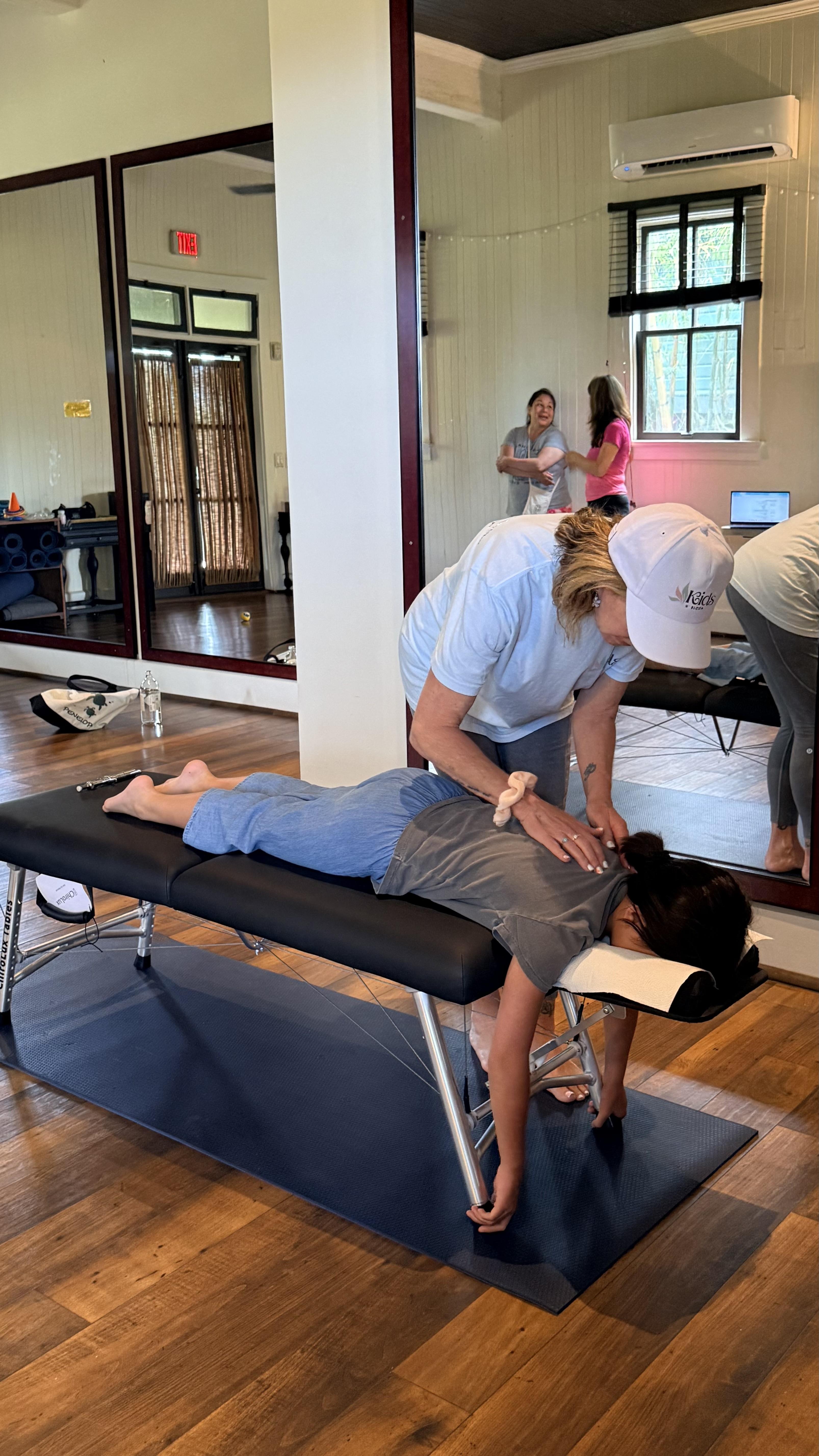 A pediatric chiropractor gently adjusting a child's spine