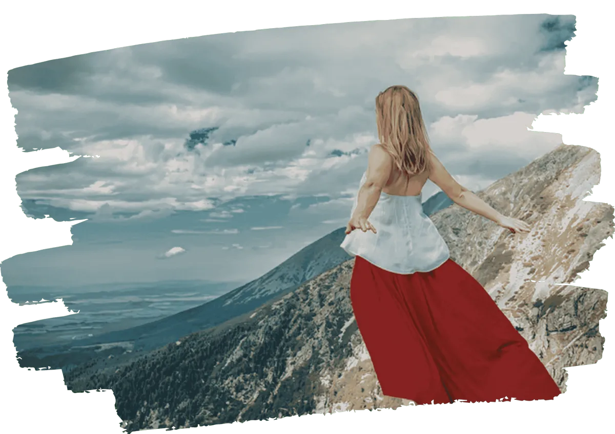 Woman standing on mountain edge overlooking vast landscape, symbolizing personal transformation and stepping into the unknown