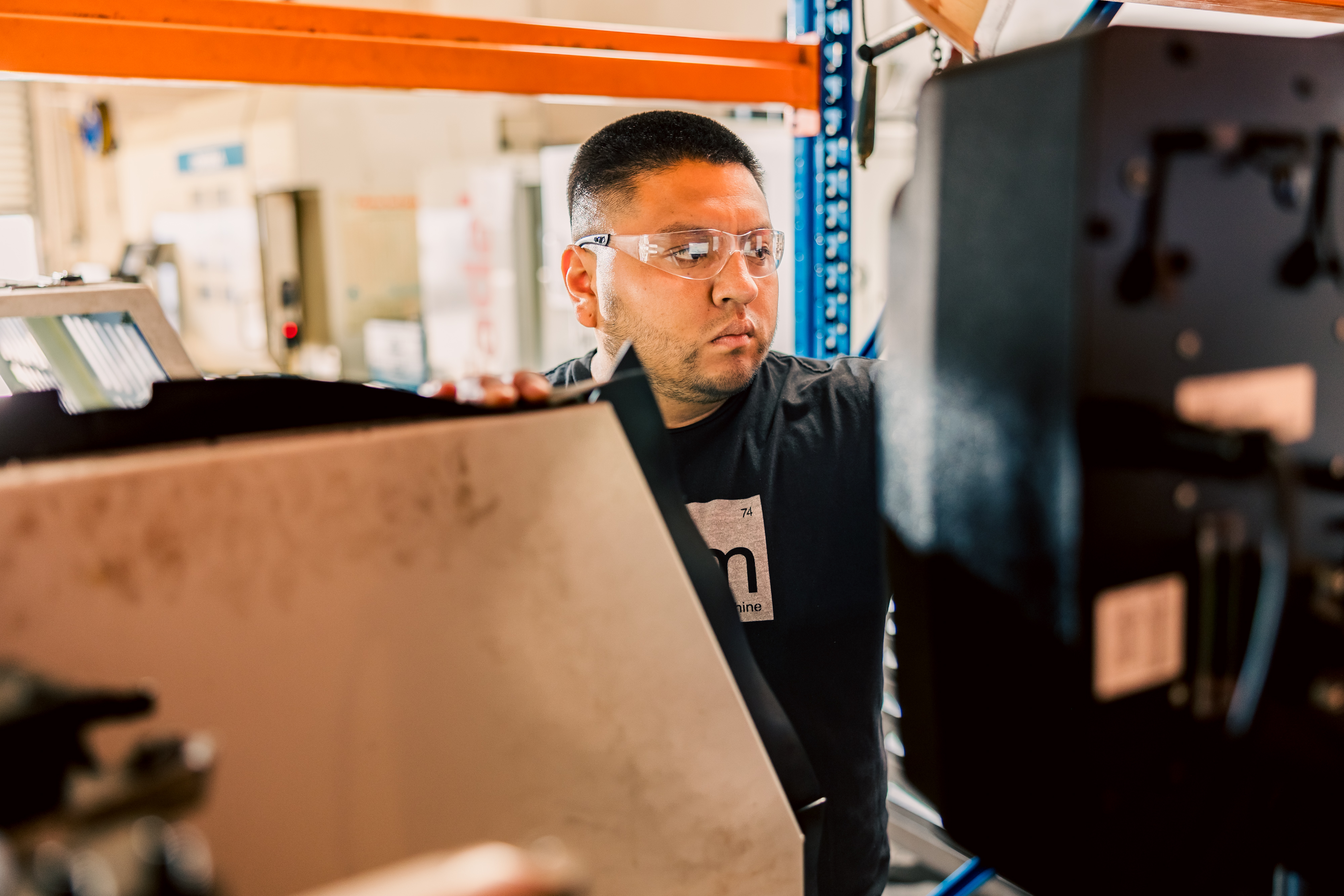 Carlos is preparing a program on the Prototrak 2470 machine in a workshop.