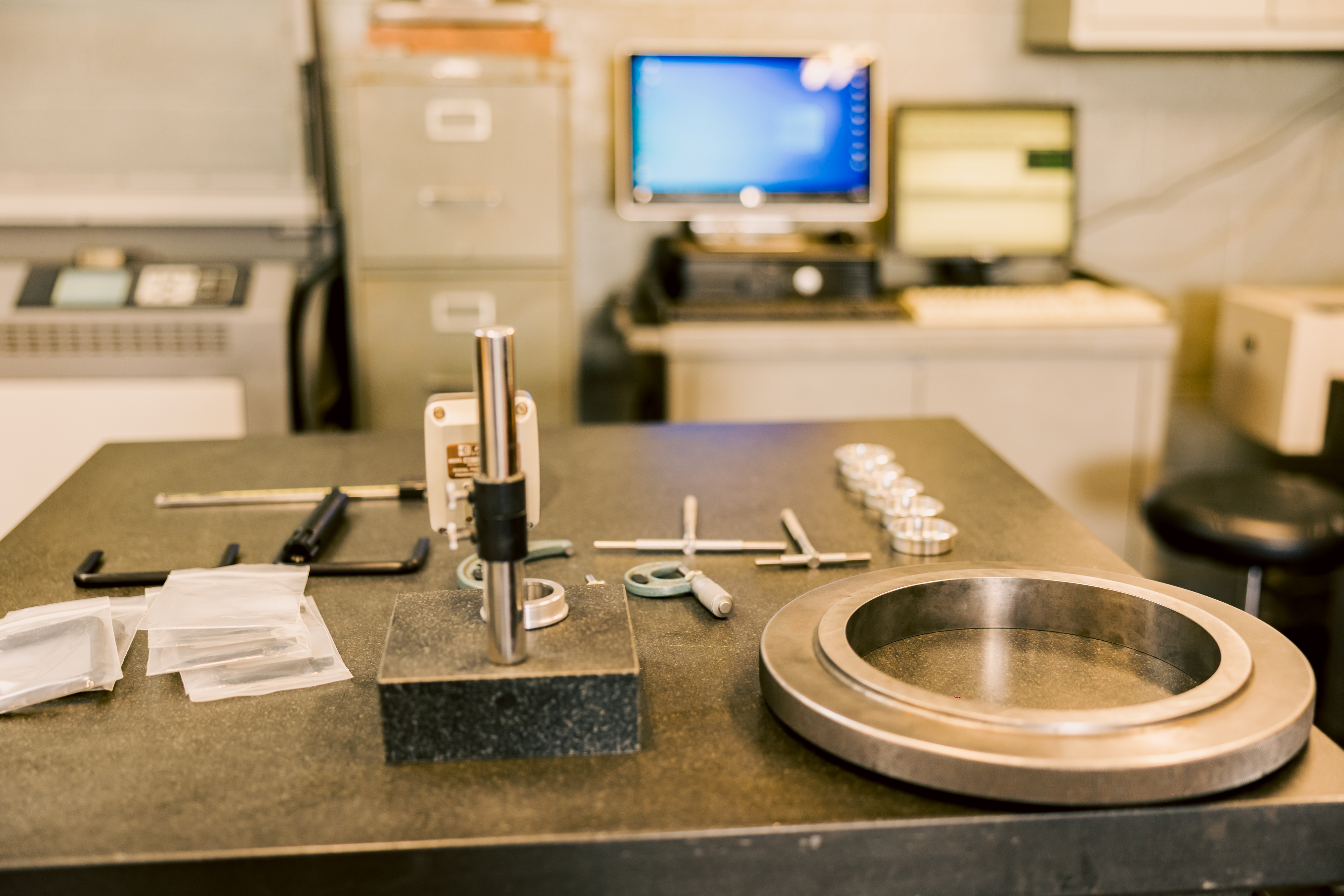 A collection of precision measurement tools on a workbench in the MTM inspection department.