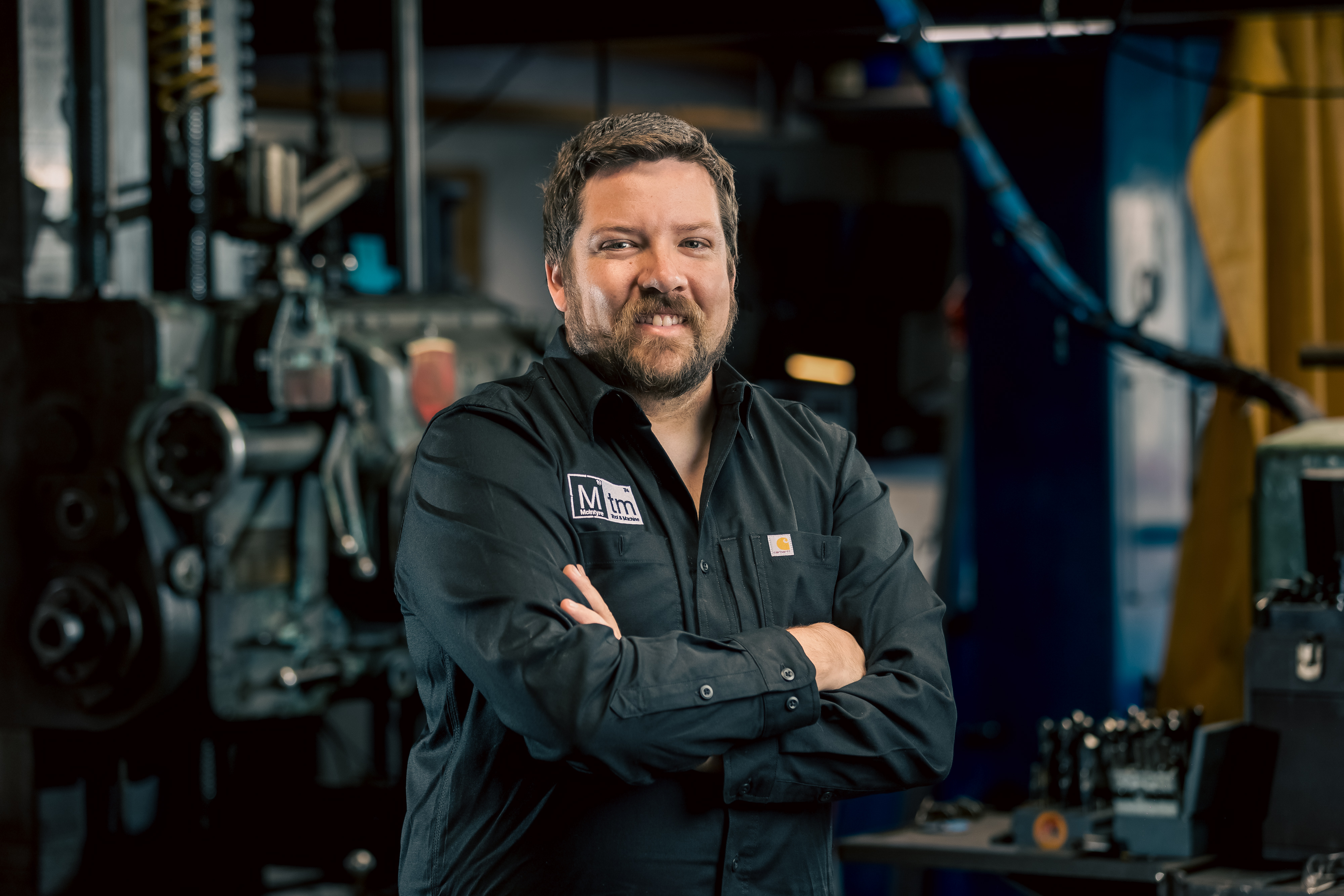 A professional portrait of Aksel Fastring, Process Manager for MTM, smiling with arms crossed.