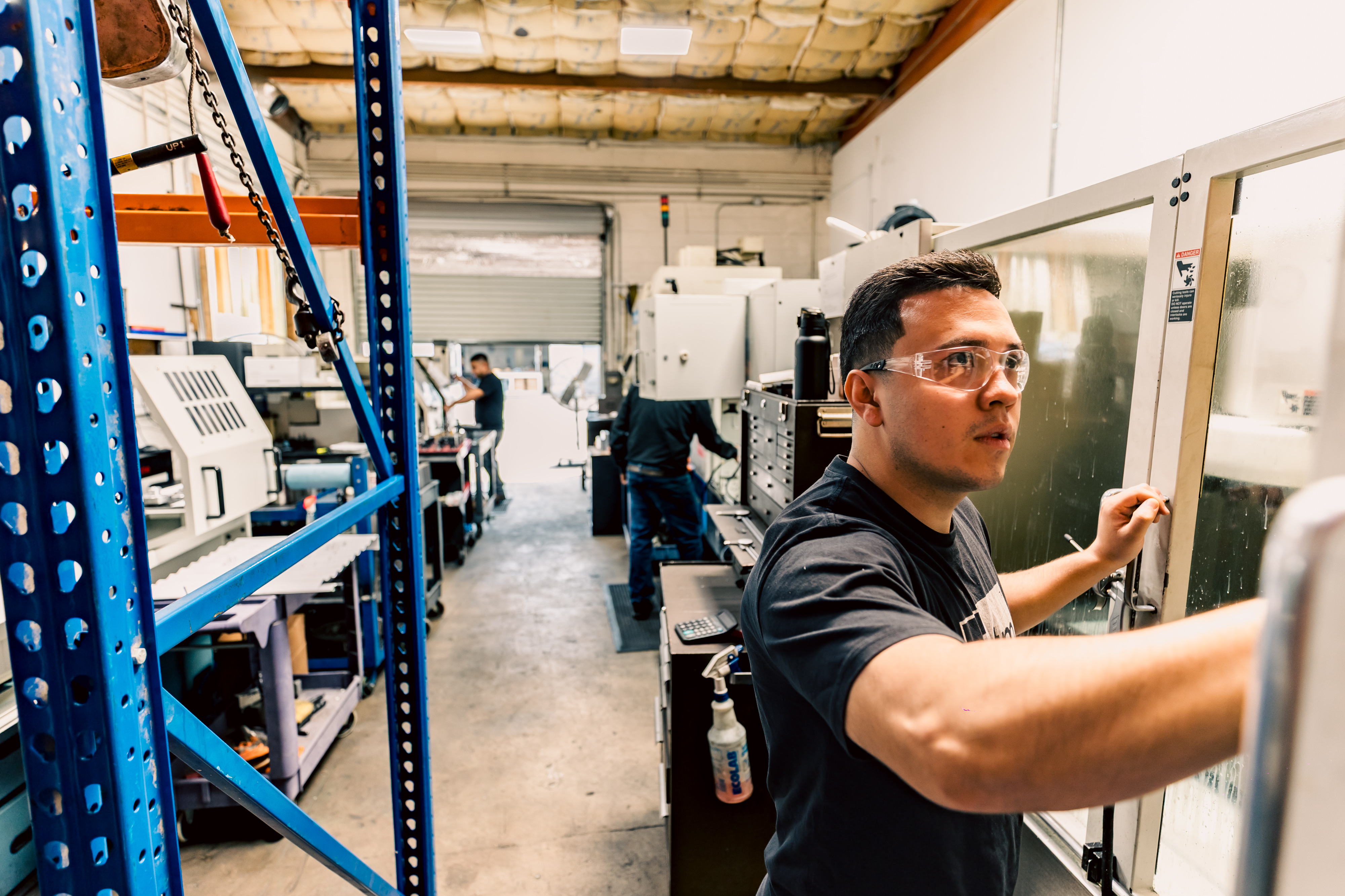 A machinist operating a Fadal 3016 machining center in the workshop