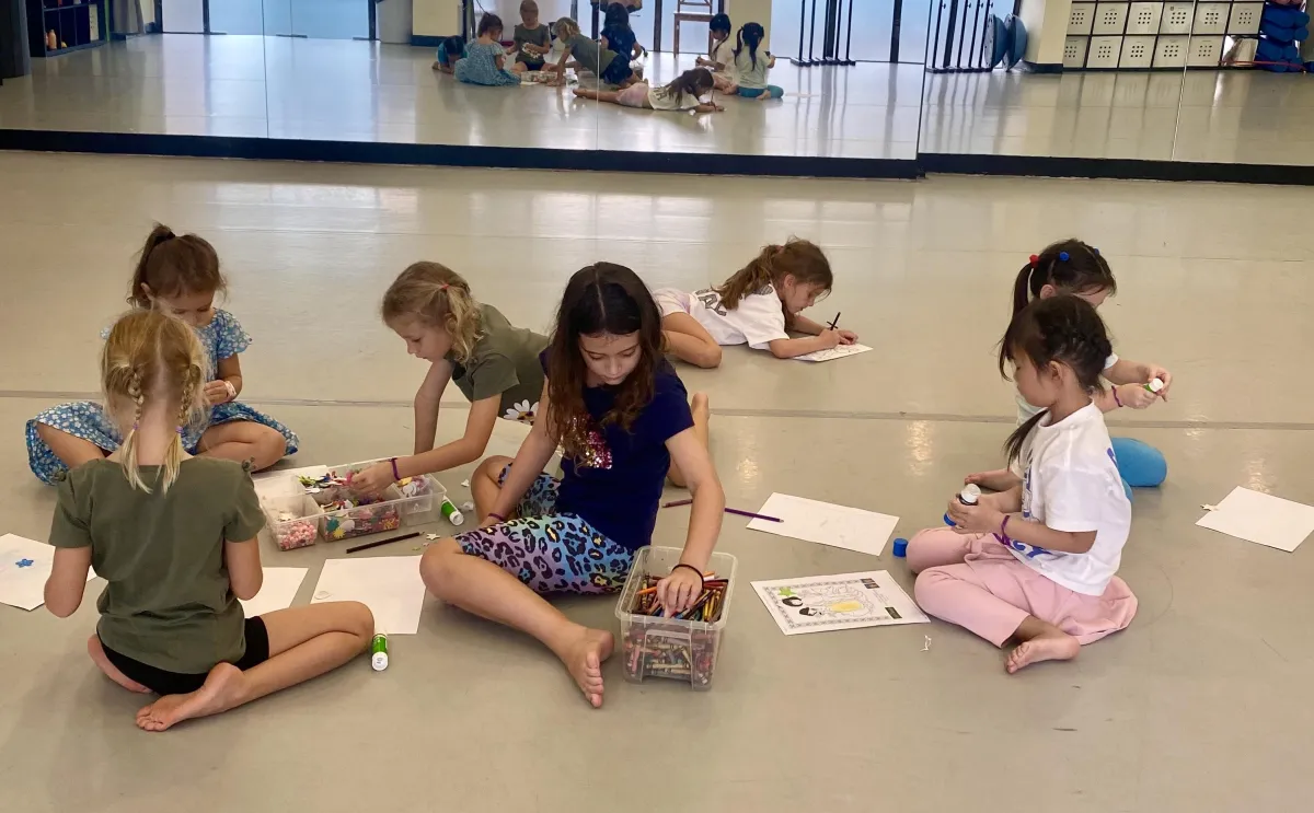 Children engaging in storybook storytelling in a whimsical setting
