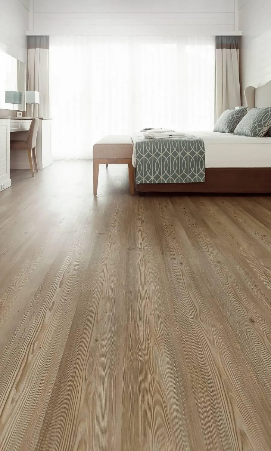 A dancer lies on the floor in a studio.