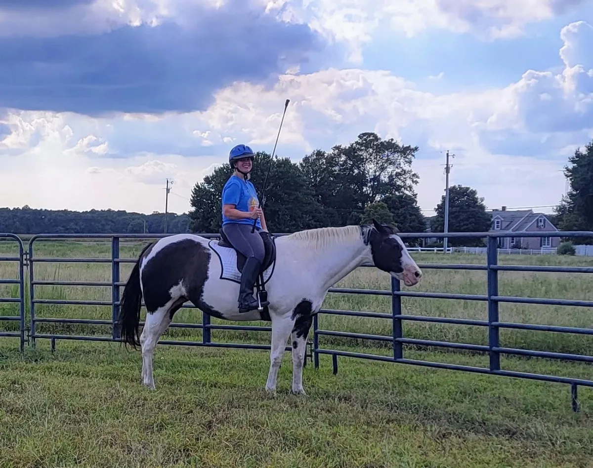 Miles Made Member staning with her horse