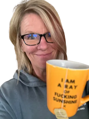 Your fearless funnel leader drinking tea out of her favorite mug, which declares her to be "a ray of fucking sunshine."