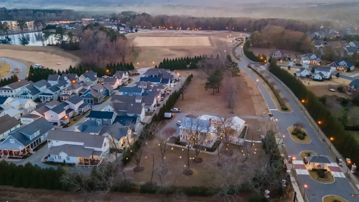 Aerial view of Flowers Plantation master-planned community in Clayton NC at dusk showing residential development and waterfront