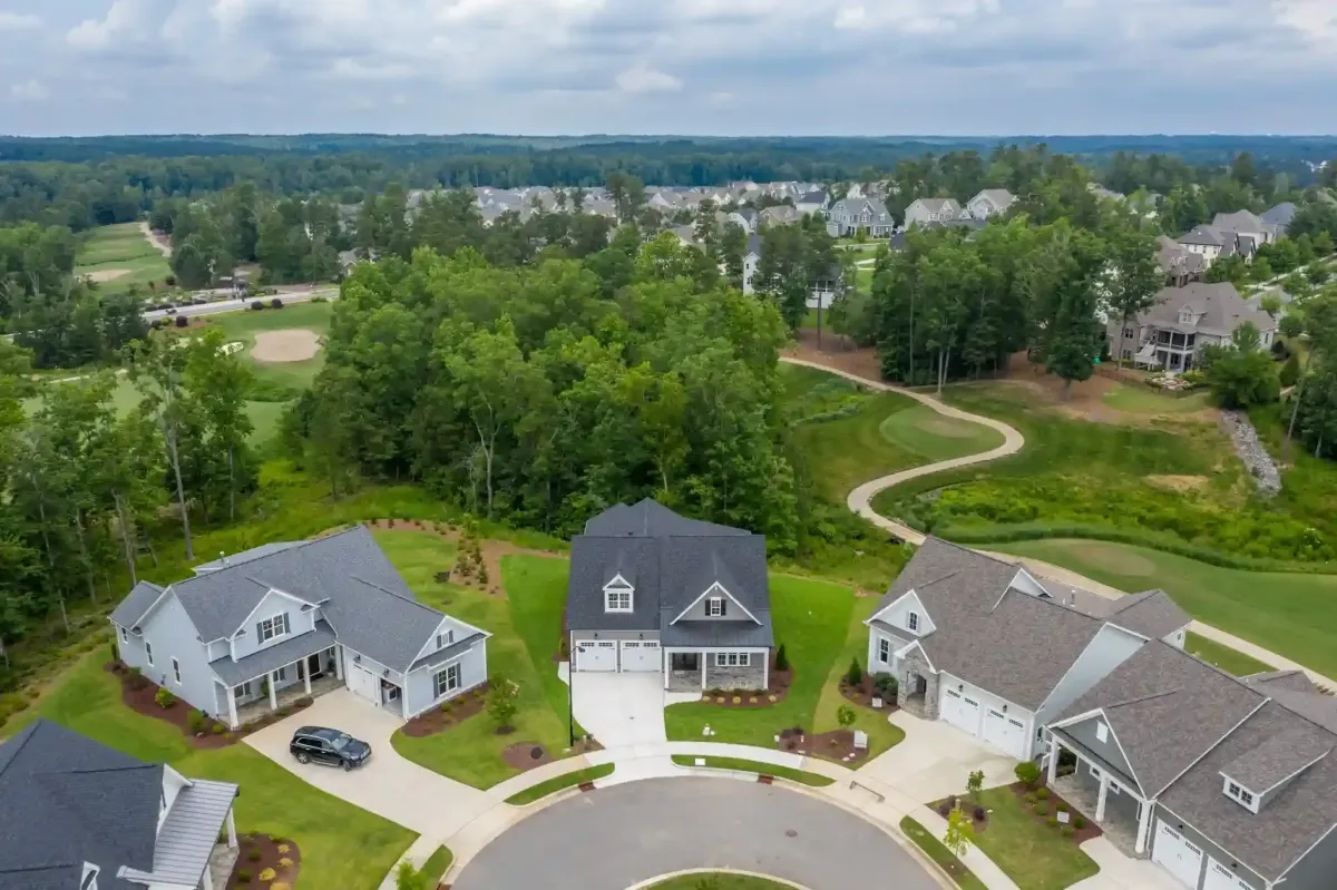 Aerial drone view of homes in 12 Oaks in HollySprings NC with golf course in back-gound