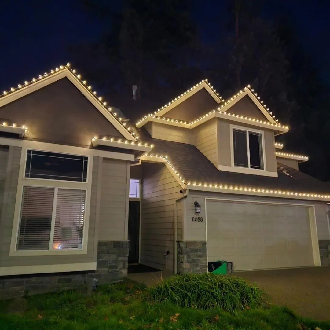 Bright LED Christmas lights installed on the exterior of a Portland home, creating a festive holiday display.