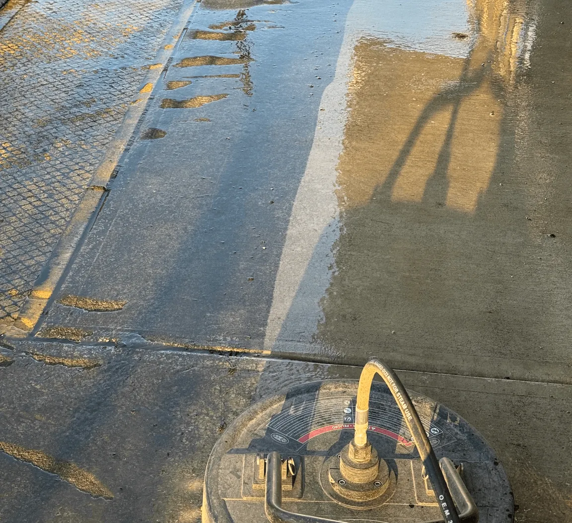 Image of a surface cleaner pressure washing a smooth concrete surface