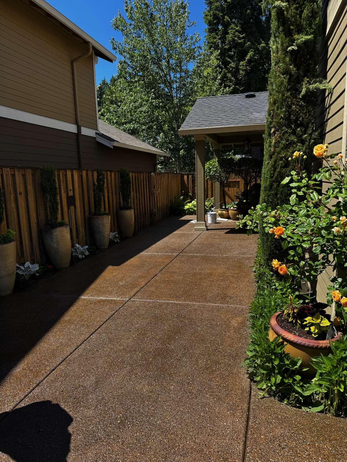 Acrylic driveway sealing in Tigard Oregon. This maintains that wet look that keeps people sealing every other year.