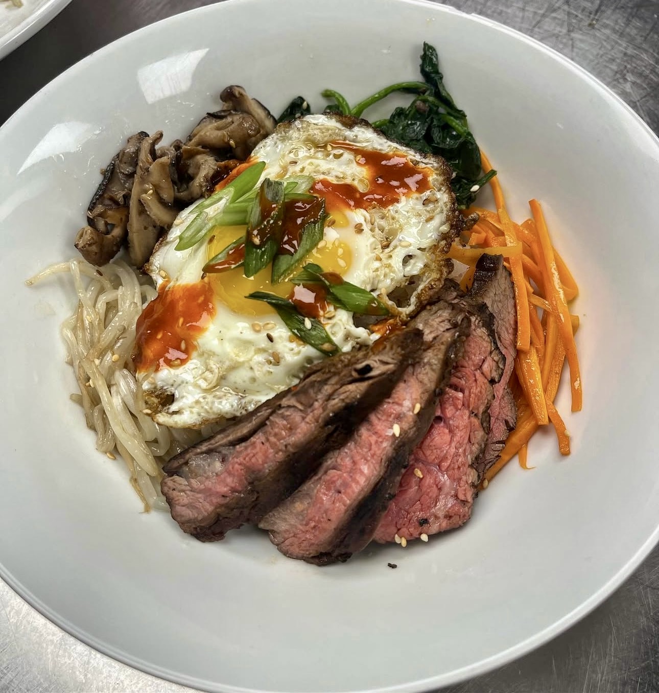 six white and brown eggs on white towel