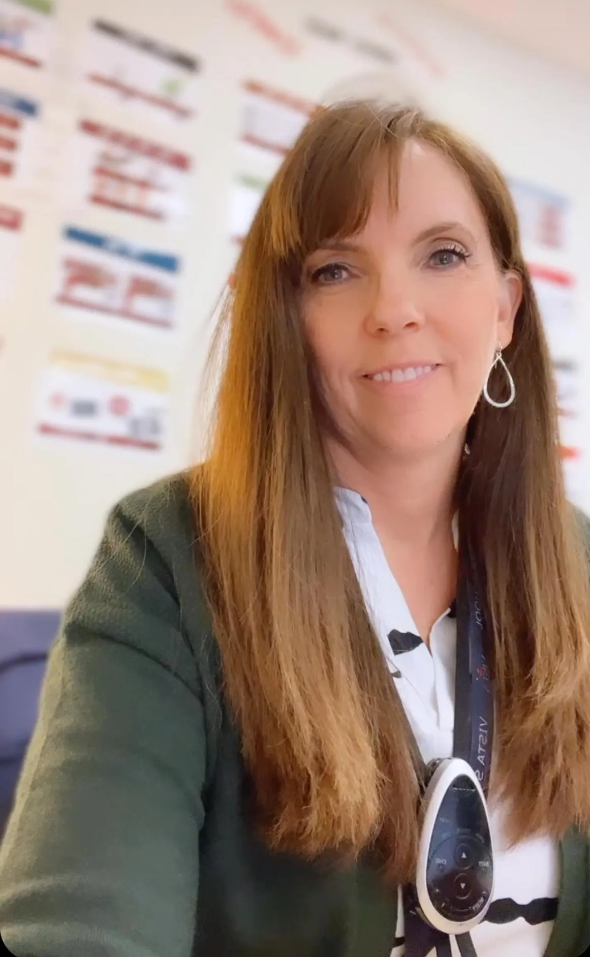 Smiling woman standing confidently in front of blurred background, representing the creator of The Manifestation Vault for soulful business growth.