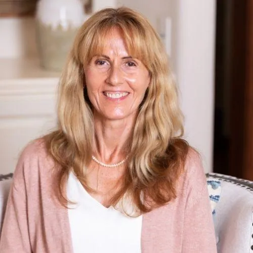 Soul-led business owner smiling after using manifestation journaling prompts