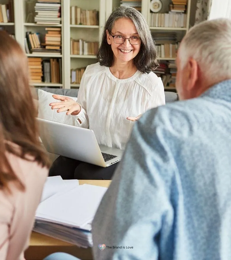 Senior woman presenting financial options to an elder couple, showcasing her expertise in financial planning for seniors.