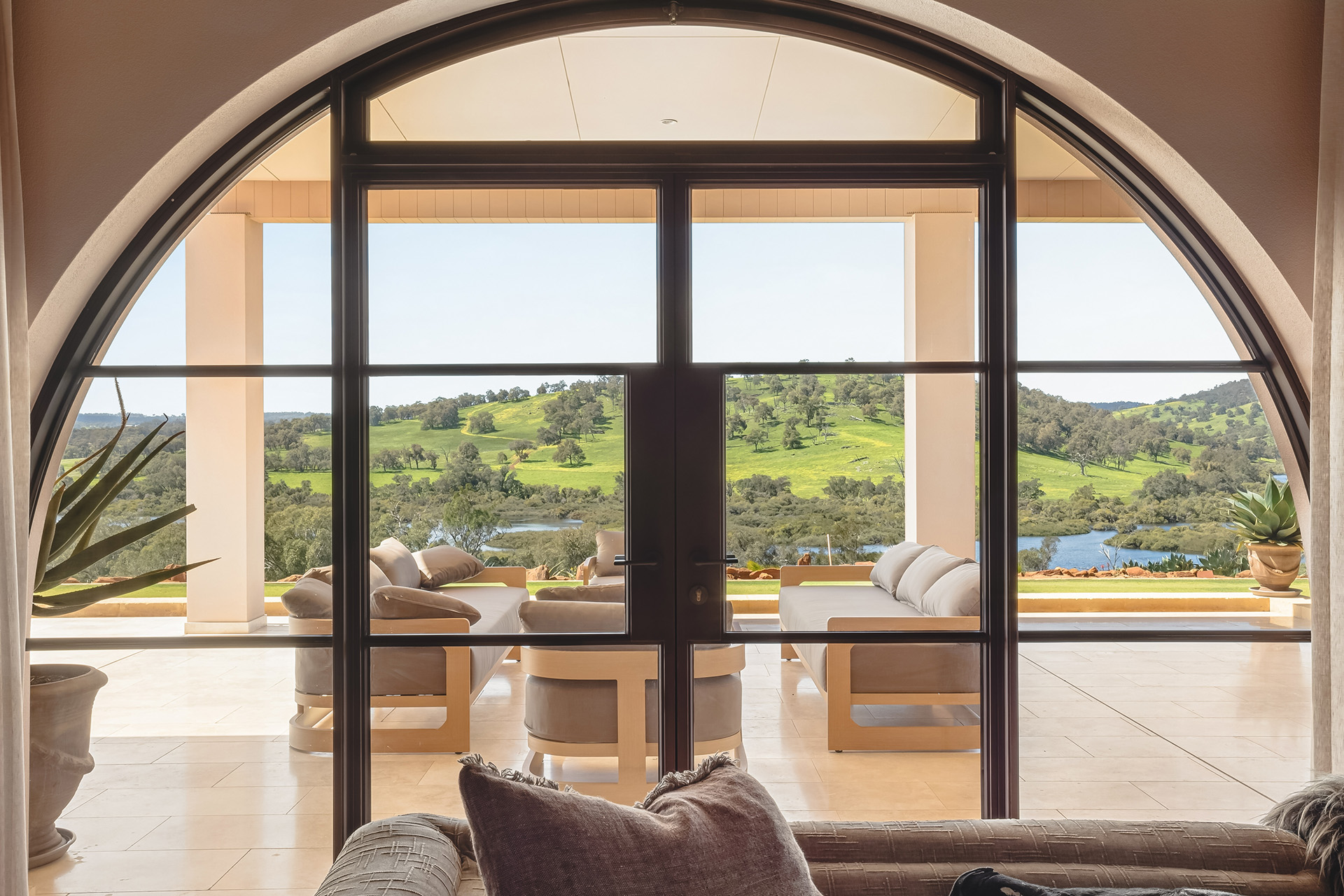 Arched windows overlooking Chittering countryside