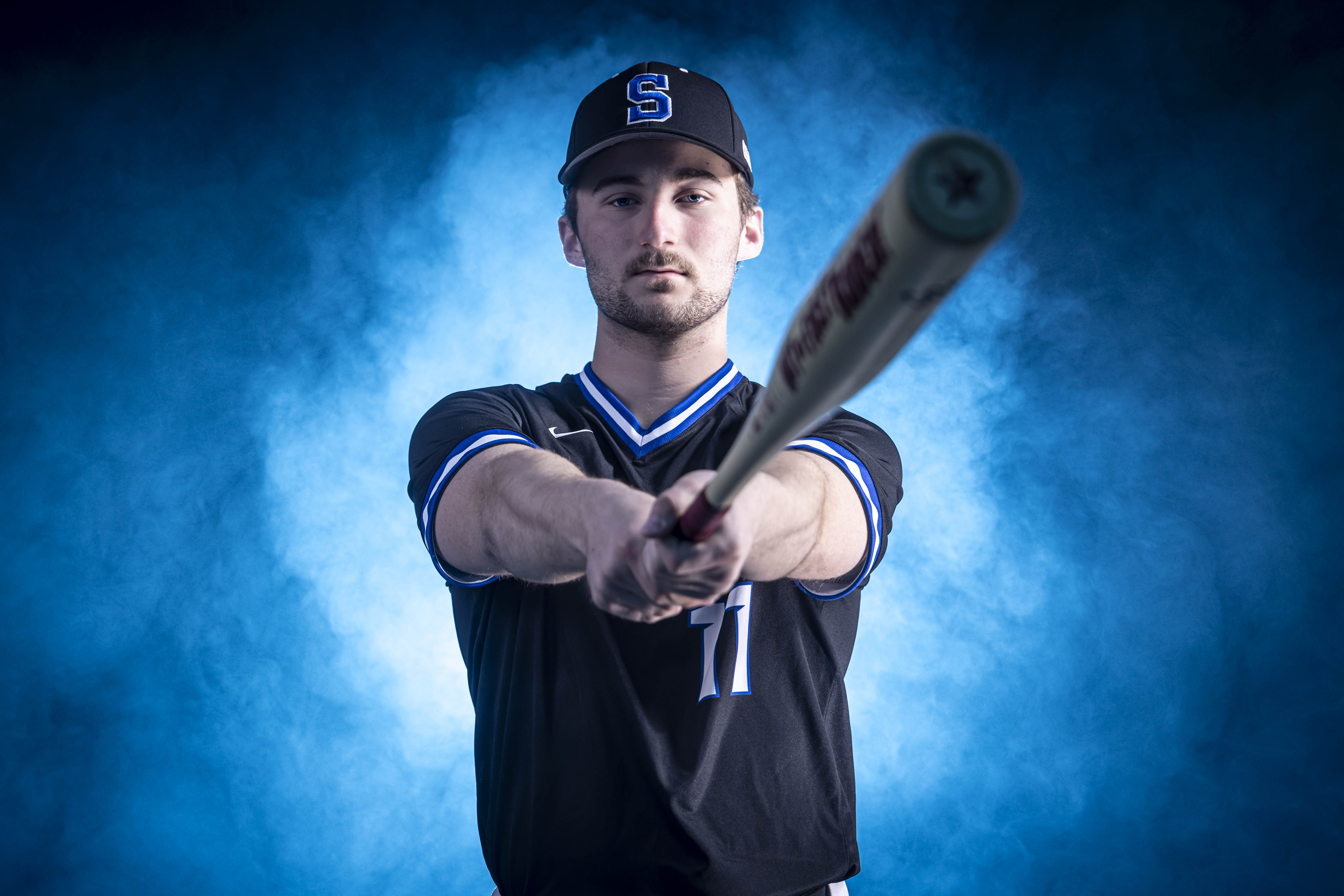 brown and black bird flying under blue sky during daytime