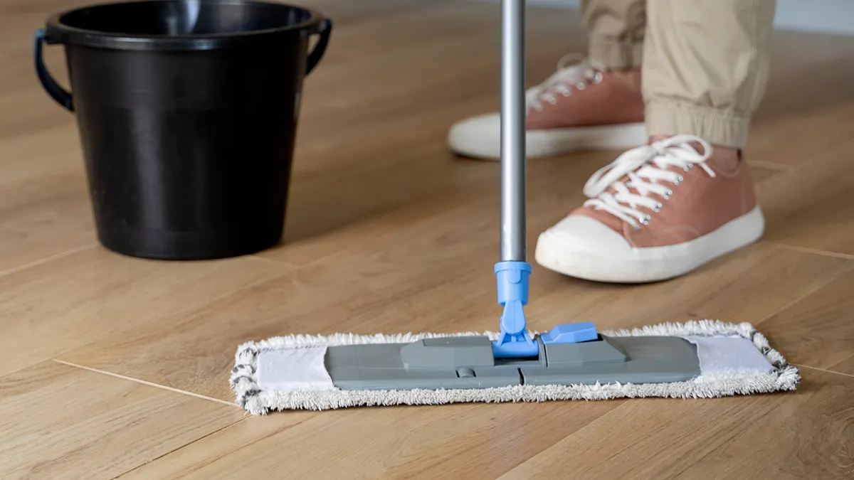 A worker washing the floor
