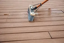 A soft brush scrubbing a composite deck clean in Lunenburg, MA