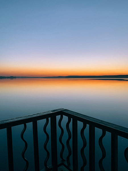 Deck edge overlooking water at sunset.