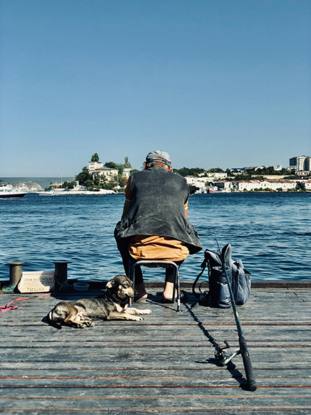 Man fishing on pier.