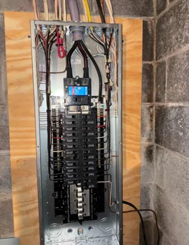 Modern electrical panel with multiple circuit breakers, showcasing upgrades for enhanced capacity and safety in residential or commercial settings.