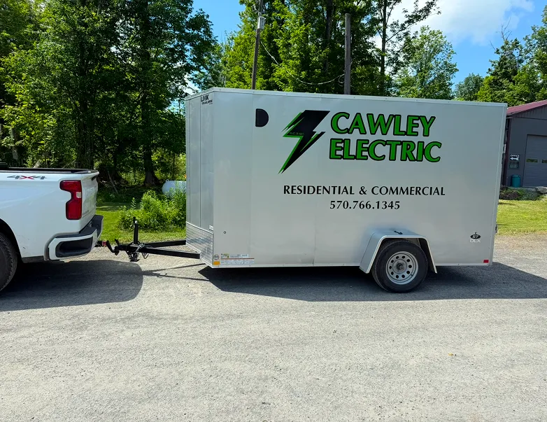 Cawley Electric branded trailer parked beside a truck, showcasing electrical services for residential and commercial needs in Northeastern Pennsylvania.
