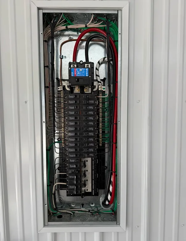 Electrical panel with multiple circuit breakers and wiring, illustrating modern electrical service upgrades by Cawley Electric for residential and commercial properties.