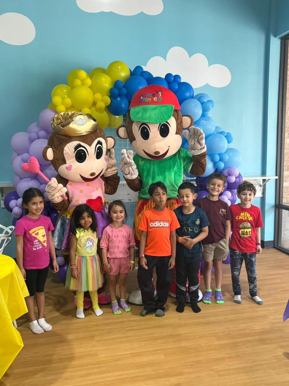 Family smiling together at a Cheeky Monkeys event