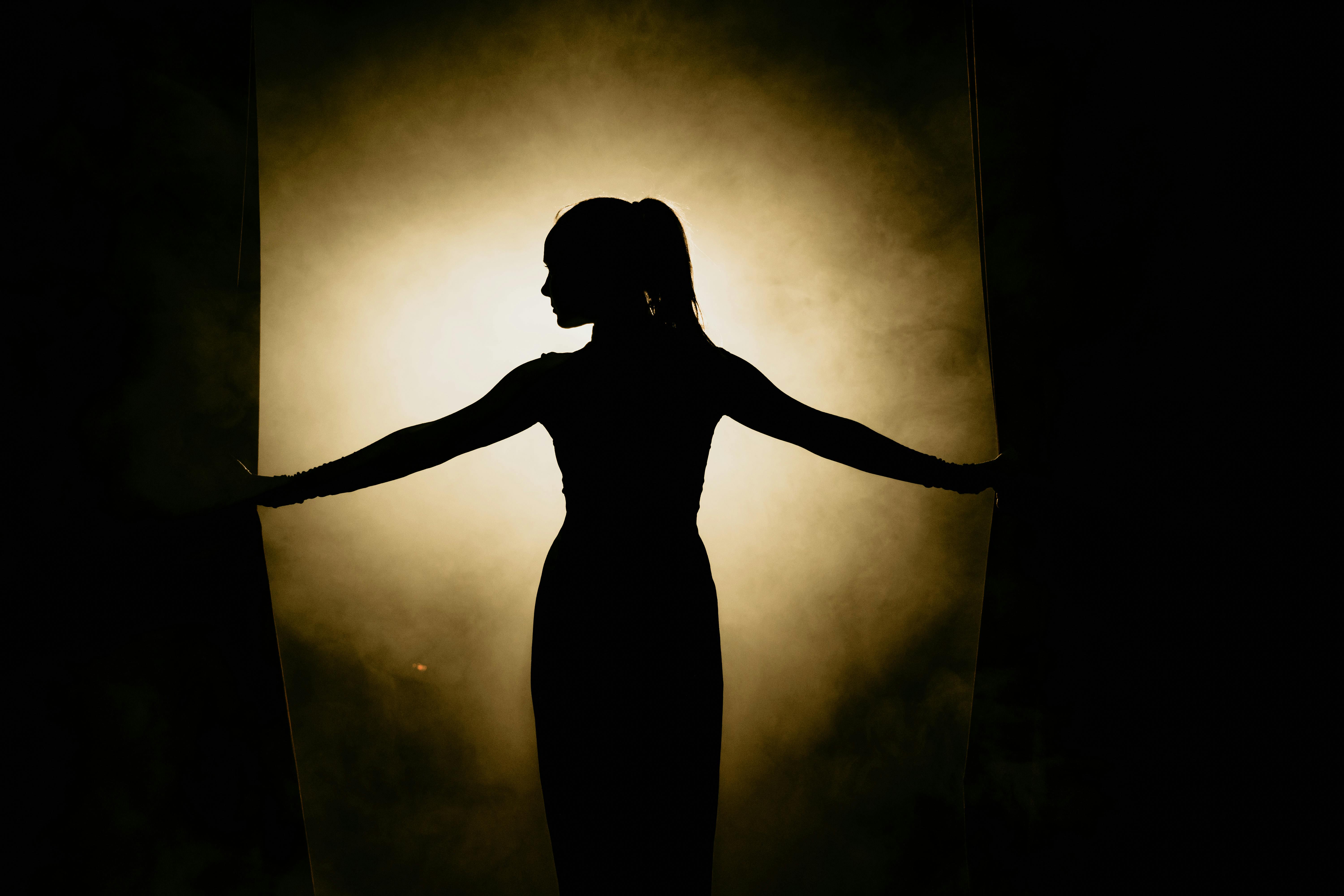 woman in black crew neck t-shirt singing