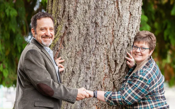 Shannon and John at golden hour, smiling side-by-side outdoors