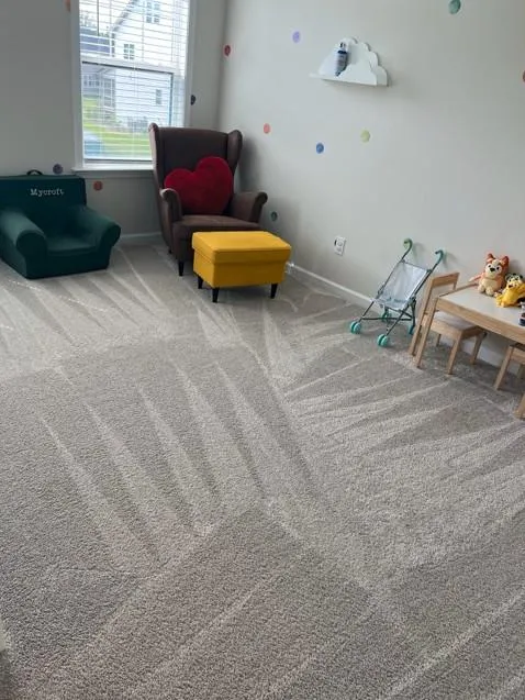 Kids playroom with clean carpets, neatly arranged toys, and freshly vacuumed floors