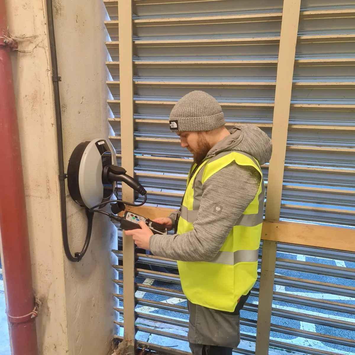 Tom Manning, director of Elektron Energy Services, installing and testing an EV charger in West Yorkshire