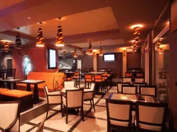 Freshly painted modern living room in Centennial CO with warm walls, natural light, and polished hardwood floors.