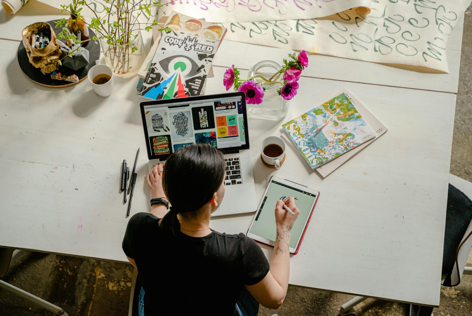 Designer working on listings at a bright studio desk