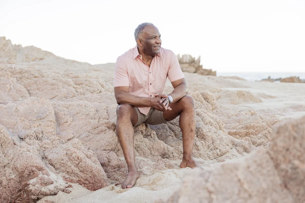 Curtis McCullom sitting at the beach.