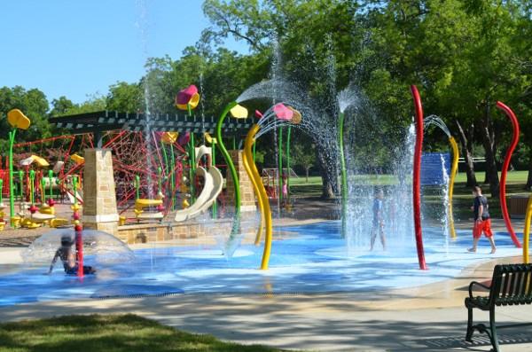 Getting wet at Dallas’ spraygrounds is a popular pastime during the summer.