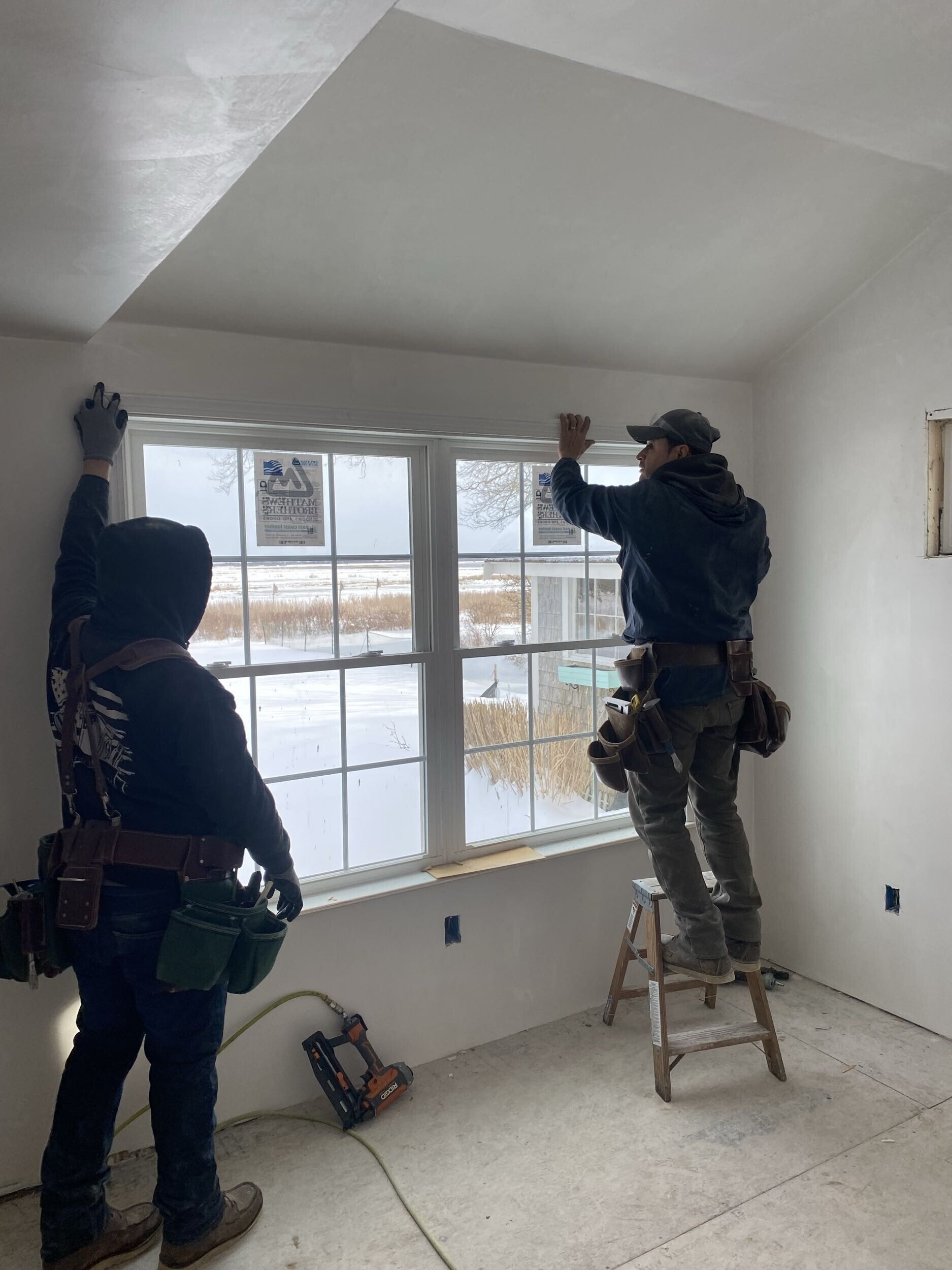 Homeowner testimonial on porch after installation, handshake with installer, window replacement visible.