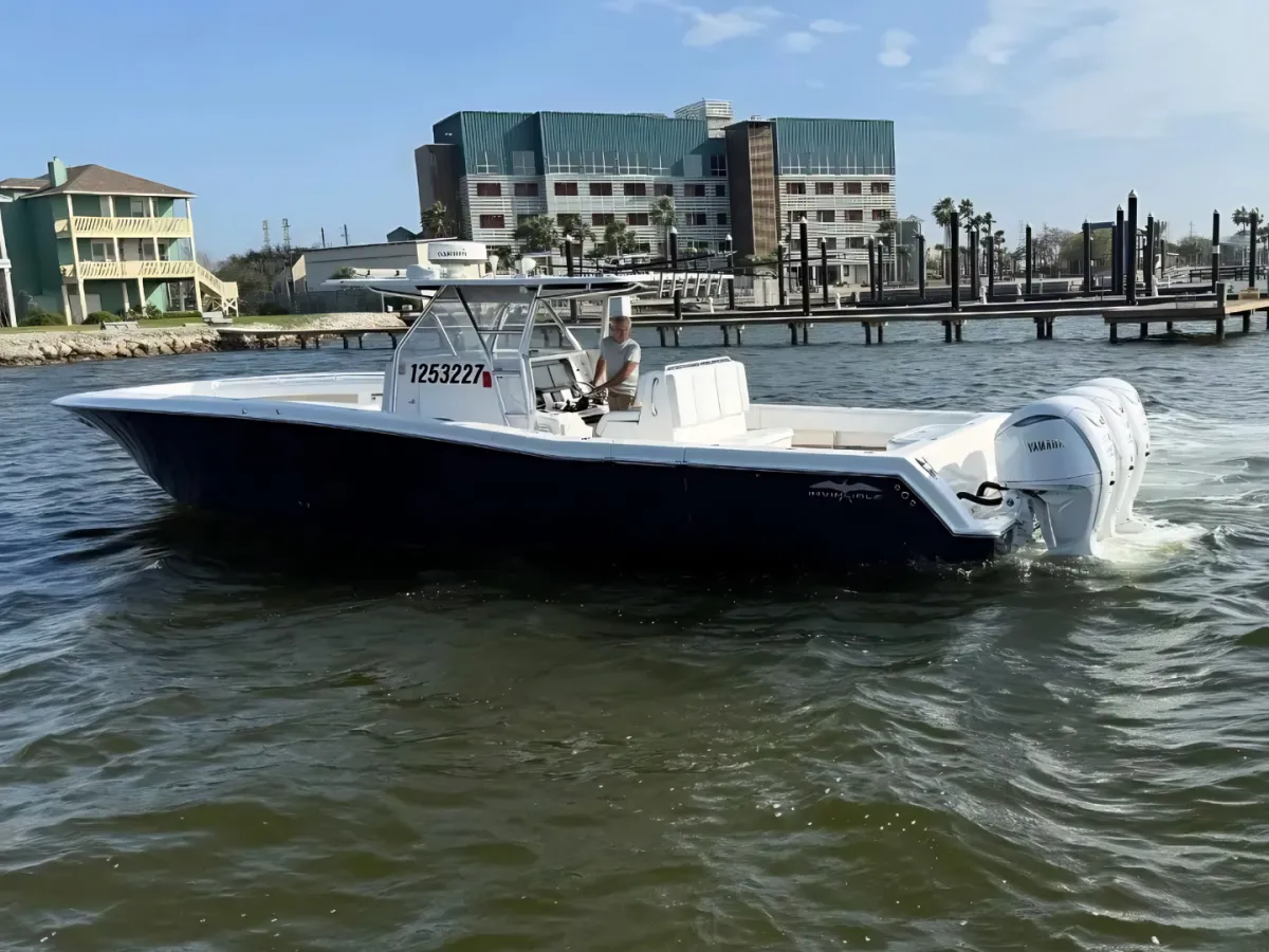Anglers fighting a fish offshore near Galveston with Captain Johnny
