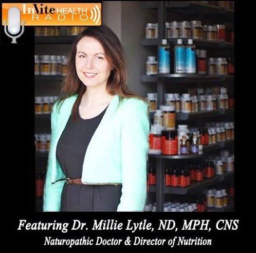 A woman holding two bottles of vitamins in her hands