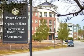 red and white concrete building beside river during daytime