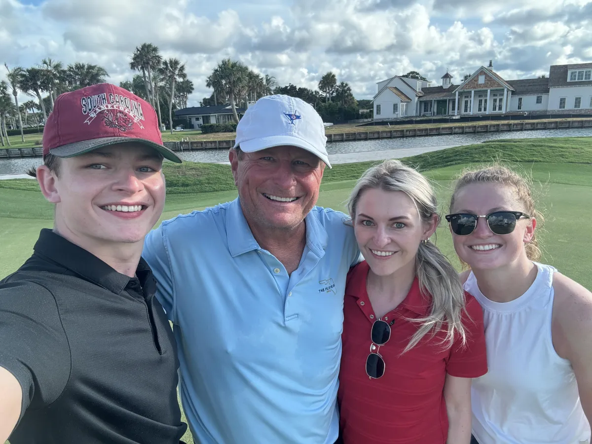 Leif Jonassen with his three kids on golf course wearing hats and sunglasses
