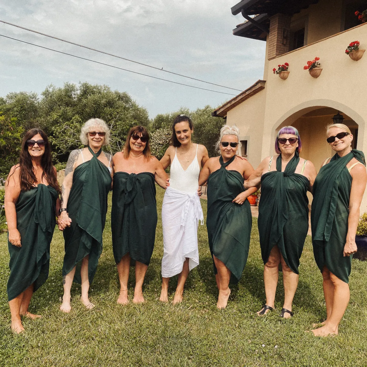 group photo of clients with Jessica, one of the hosts outside the location in the beautiful gardens